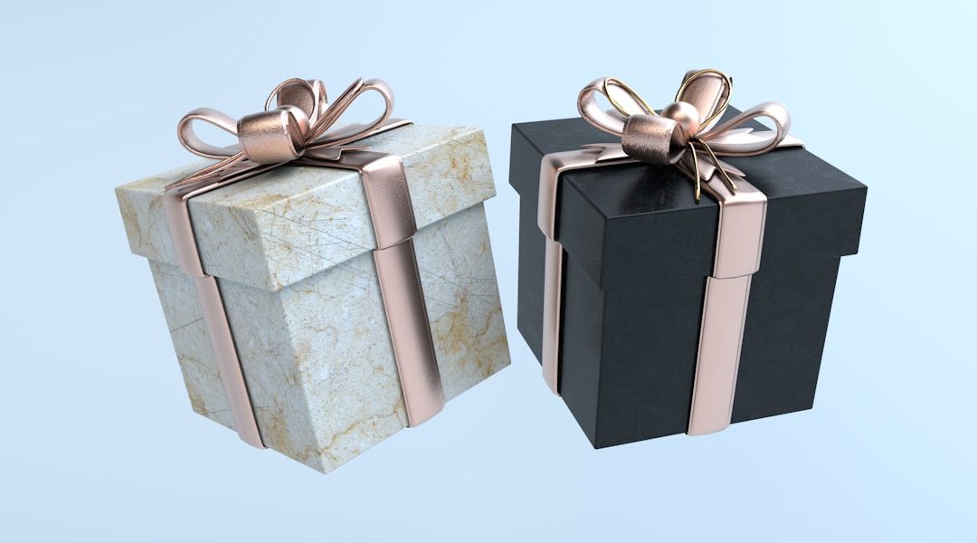 Two elegant gift boxes with ribbons on a light background.