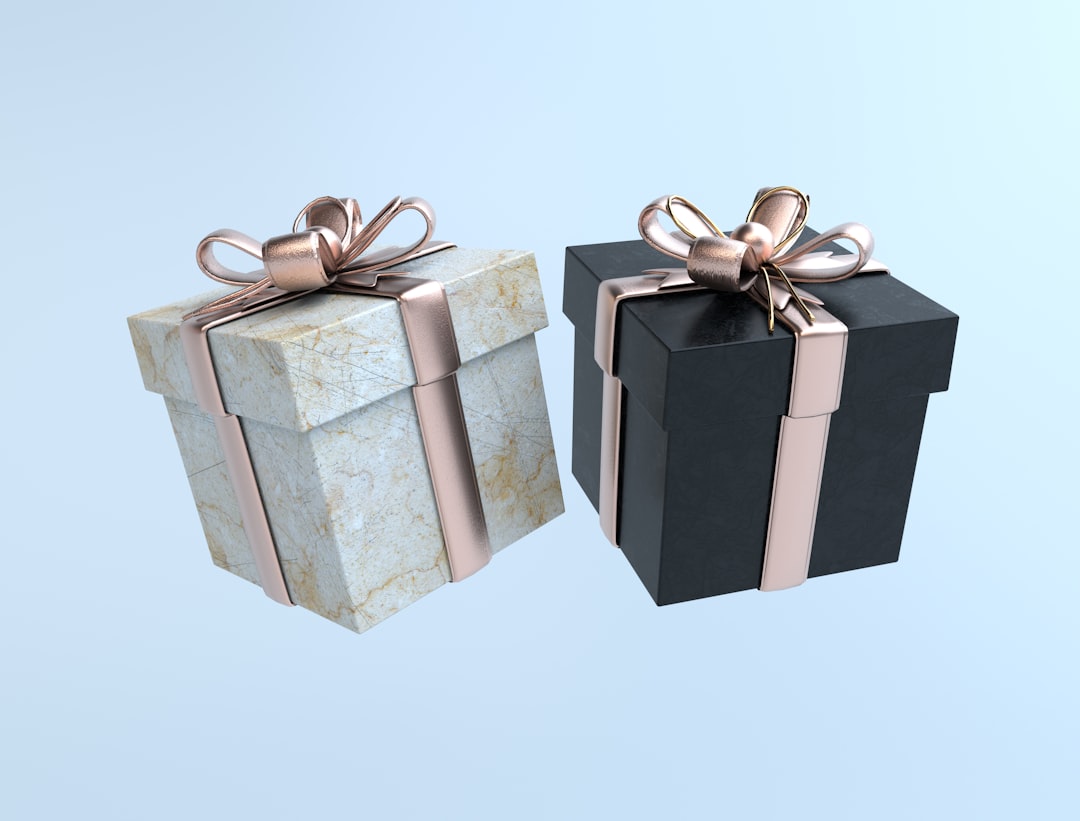 Two elegant gift boxes with ribbons on a light background.